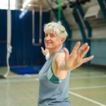 Older woman practising a standing balance exercise — balance training for falls prevention in Logan QLD