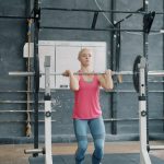 Adult training with a barbell under a coach’s guidance — building the strength and power that predict healthy ageing
